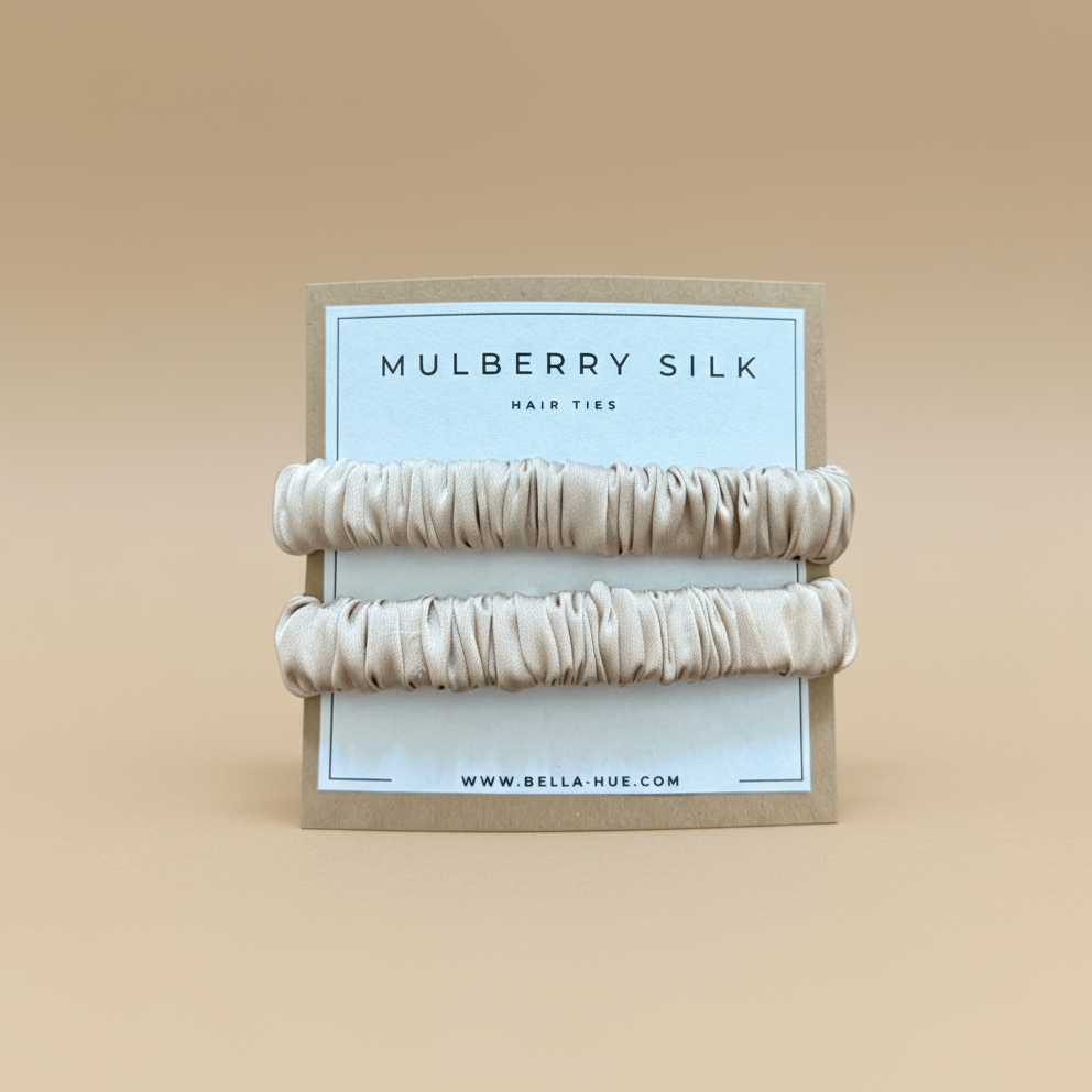Two beige mulberry silk hair ties on a white background with a Bella Hue branded card.