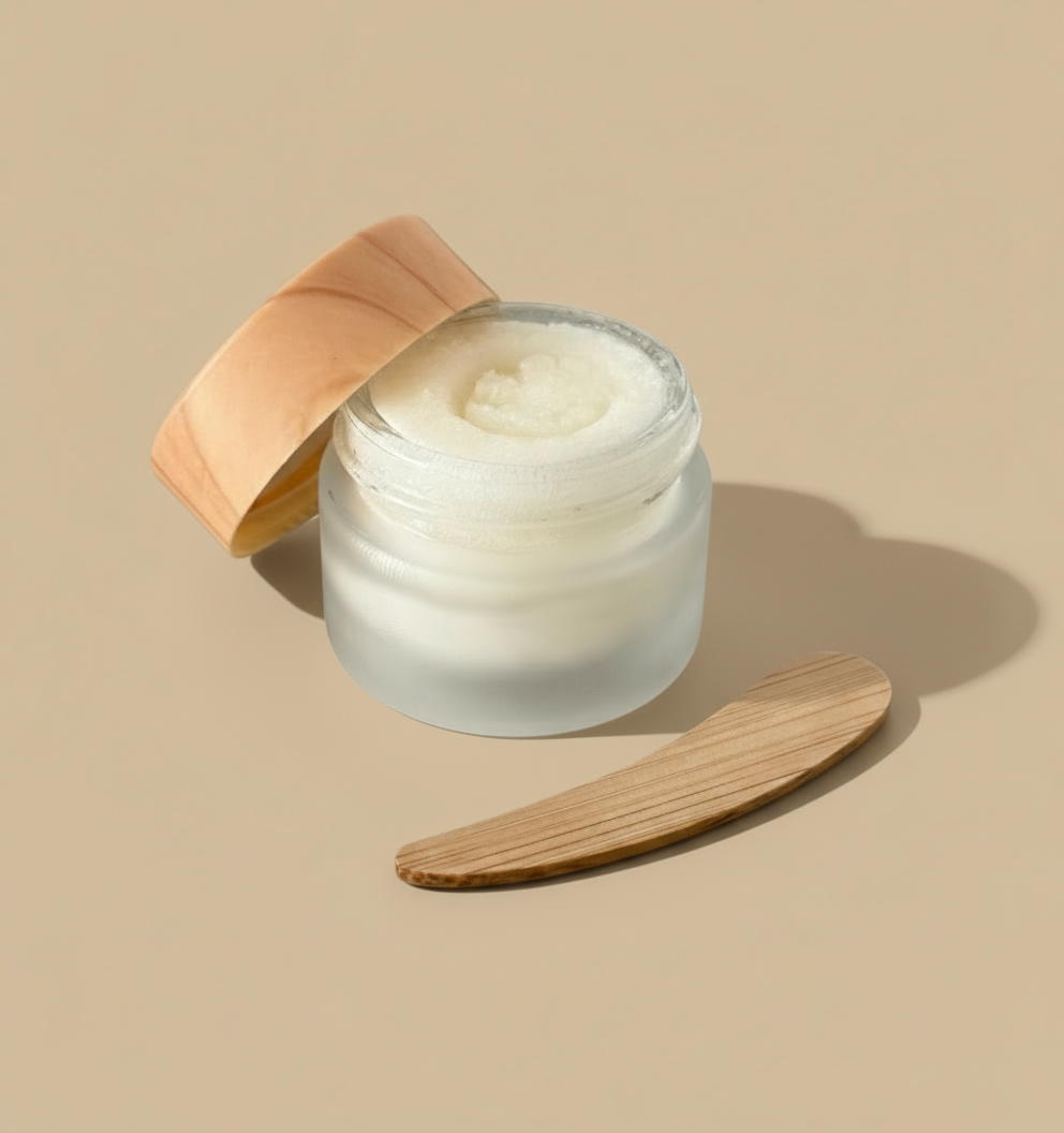 Skincare jar with wooden lid and applicator on a white background