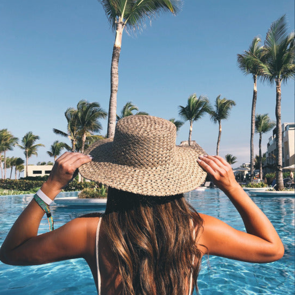 How to Protect Your Hair From Pool + Beach Water