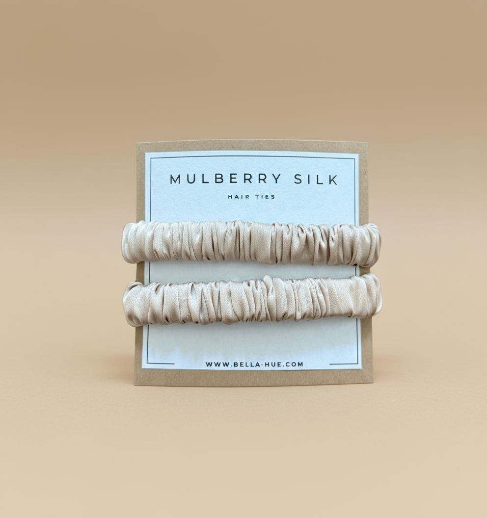 Two beige mulberry silk hair ties on a white background with a Bella Hue branded card.
